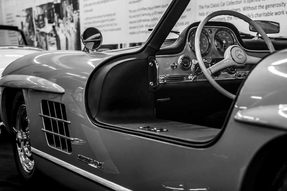 a black and white photo of a classic car