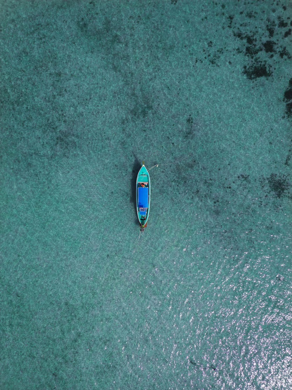 a small boat floating on top of a body of water