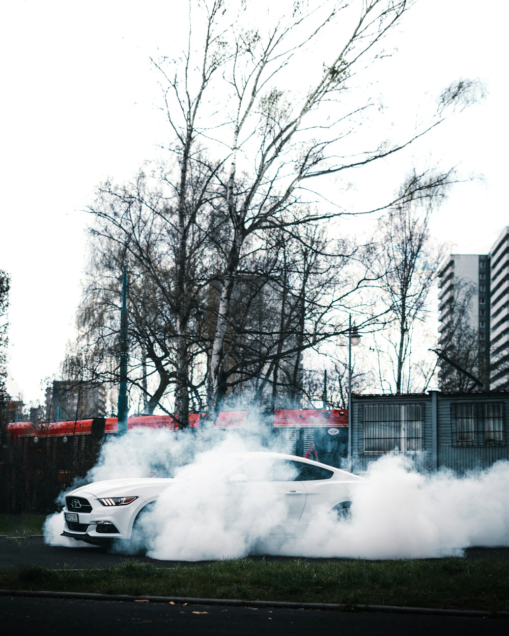a white car with a lot of smoke coming out of it