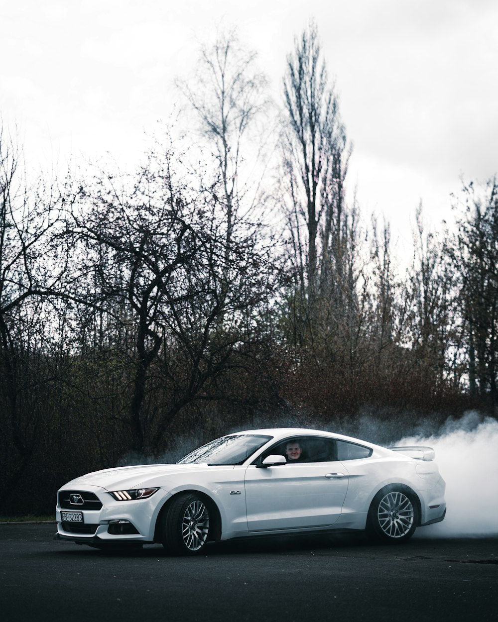 a white car with a lot of smoke coming out of it