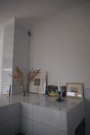 Minimalist living room corner featuring a ceramic sculpture on a wooden shelf.