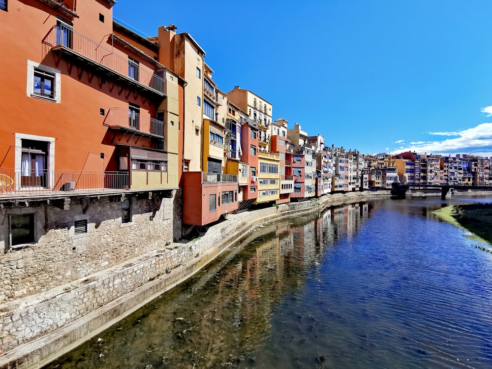 a river running through a city next to tall buildings