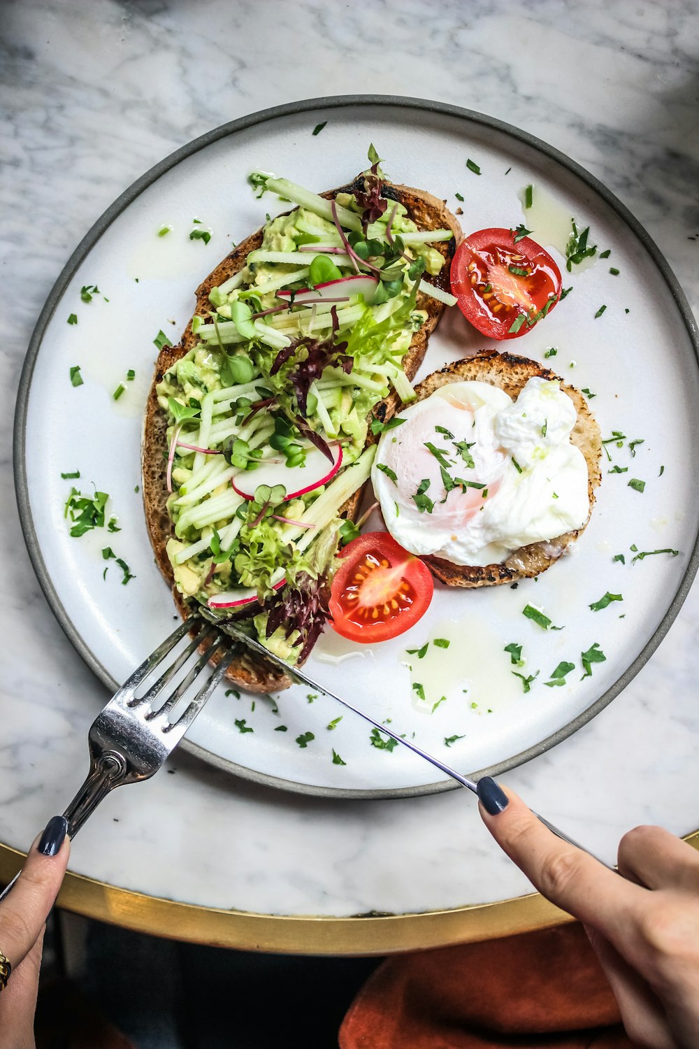 a white plate topped with an open face sandwich