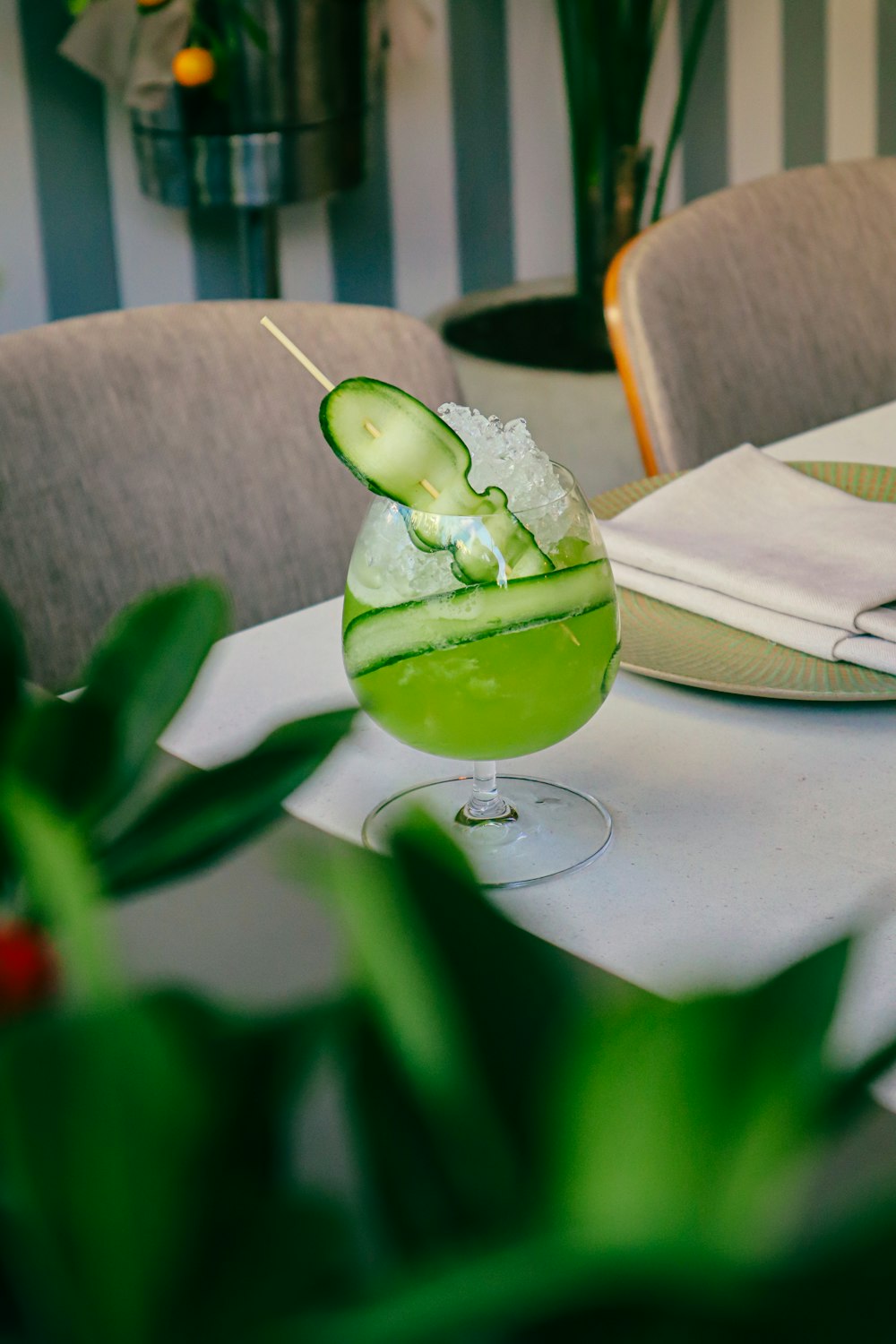 a cucumber in a glass sitting on top of a table