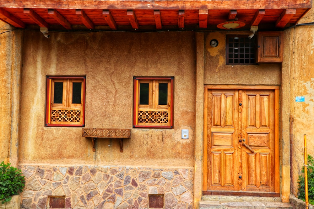 a building with two windows and a wooden door