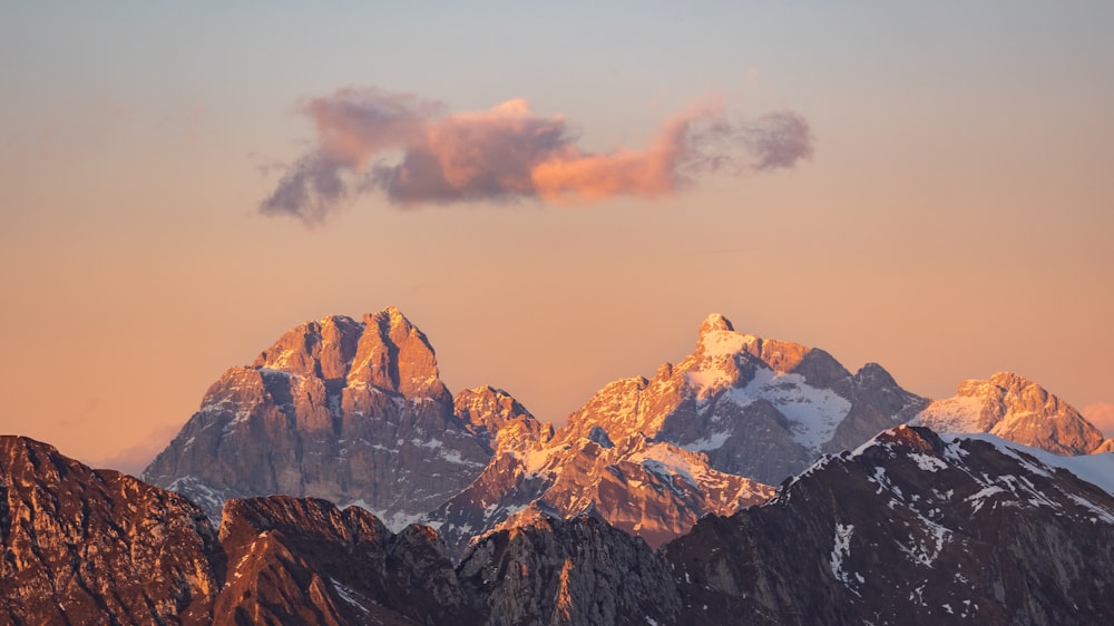 a mountain range with snow covered mountains in the background