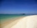 A serene beach view with clear blue waters and soft white sand, perfect for a relaxing vacation.