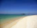 A serene travel destination with soft beige tones and inviting blue skies.