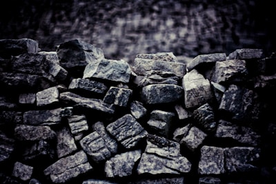 Close-up of raw mineral stones stacked in a warehouse.