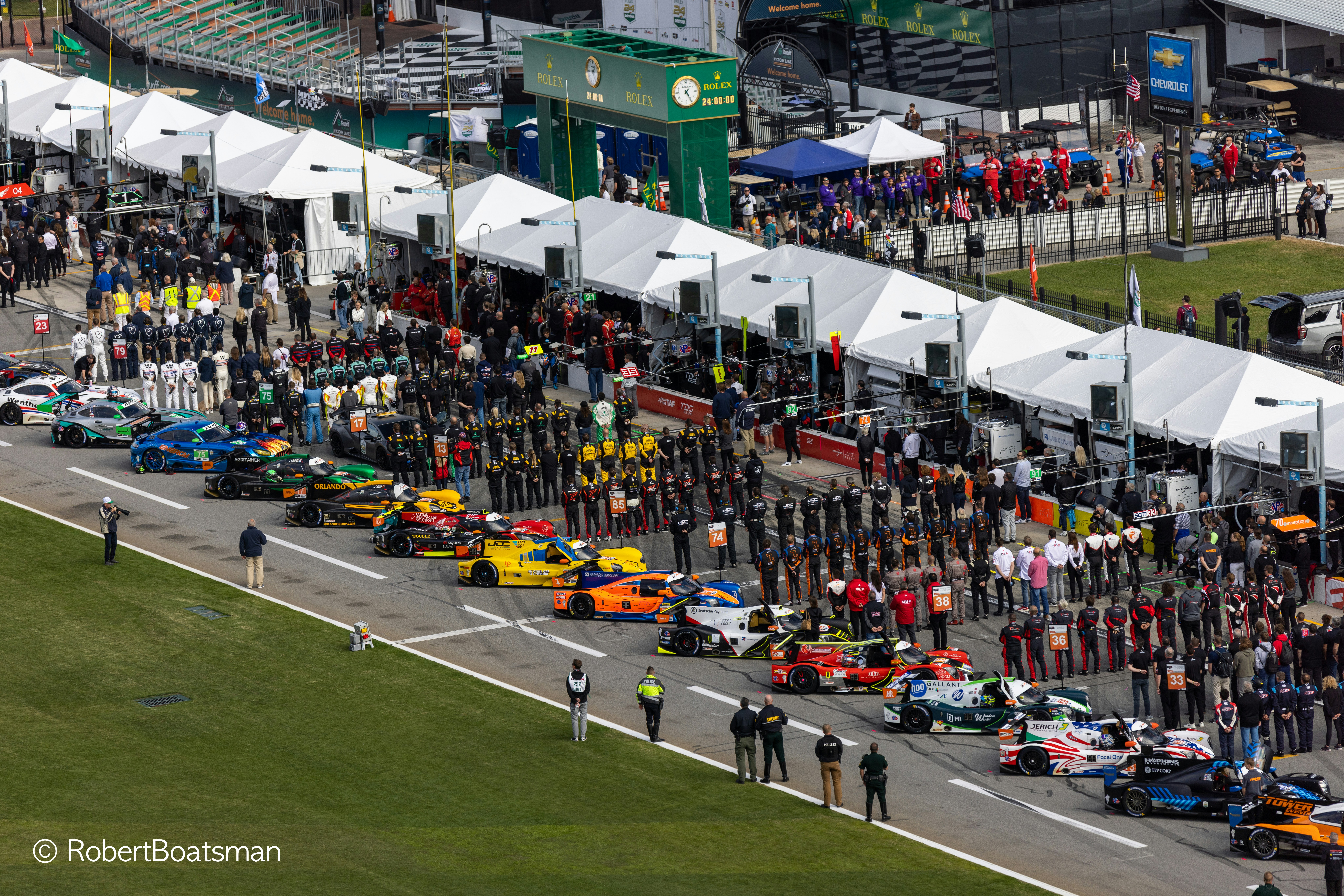 A group of people standing around a race track photo – Free People ...