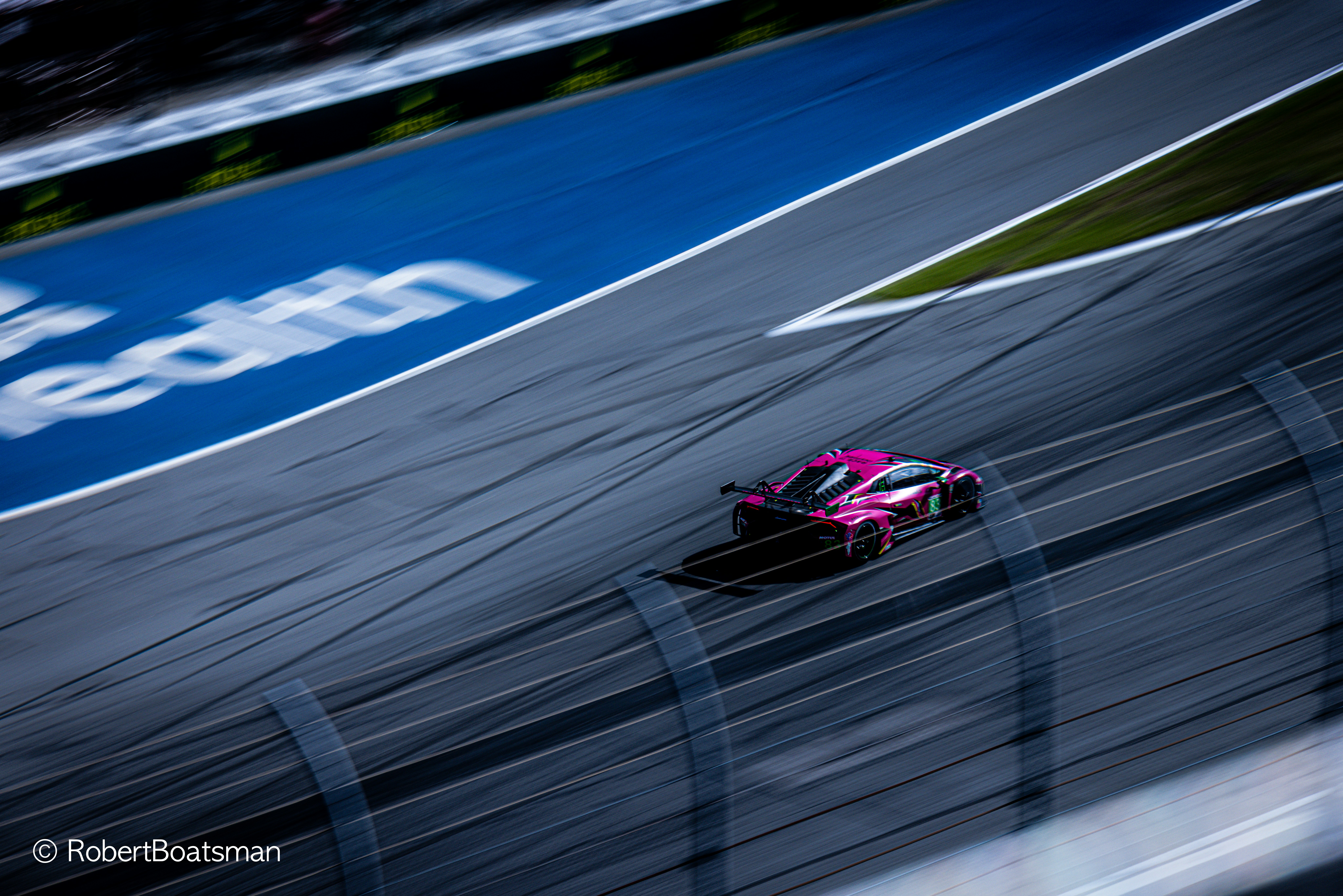 A pink car driving down a race track photo – Free Image on Unsplash