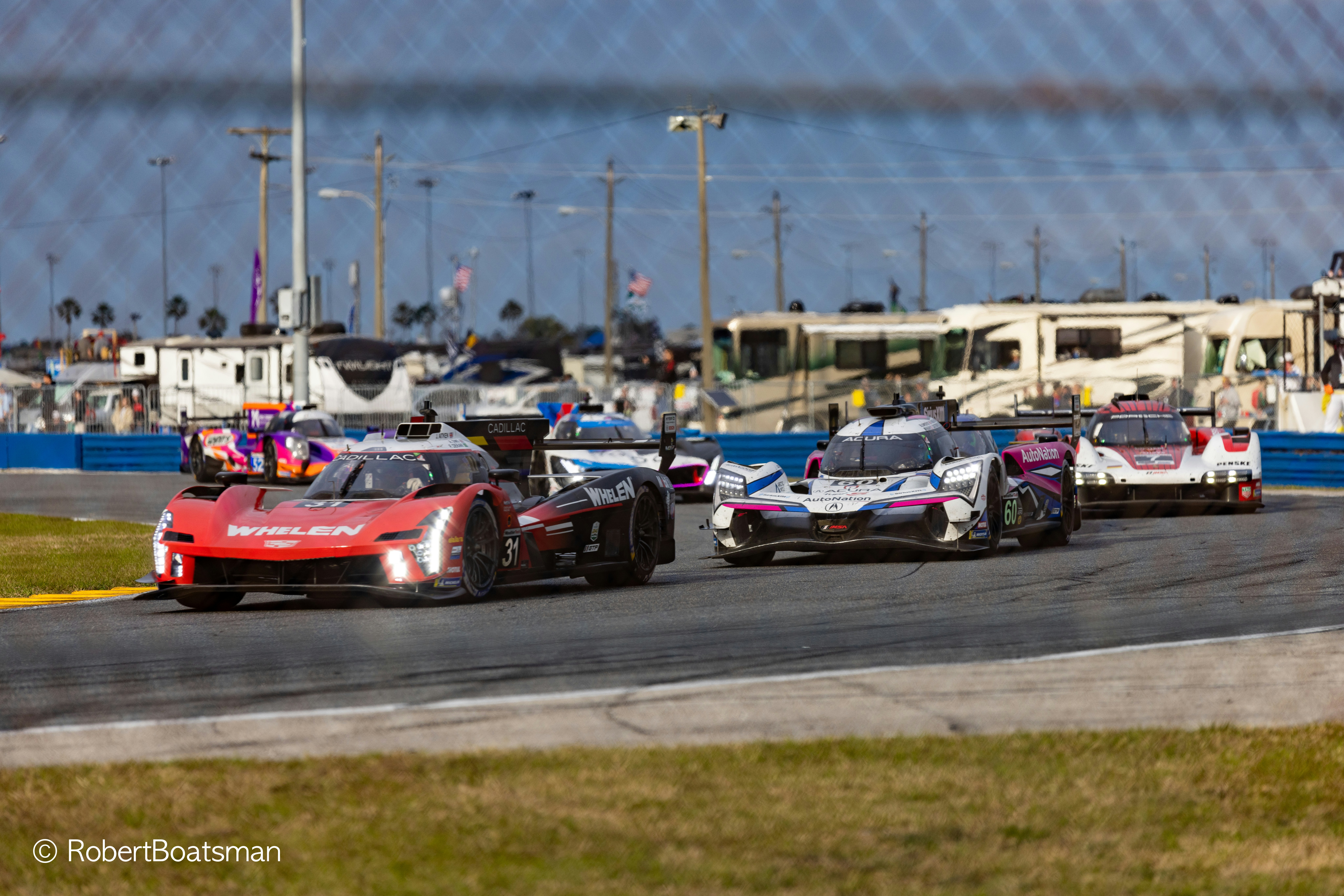 A group of race cars driving down a race track photo – Free Car Image ...