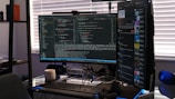 Developer coding Python scripts for automation on dual monitors