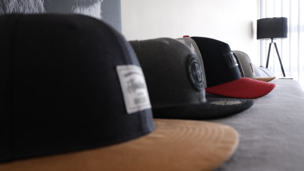 a row of hats sitting on top of a bed