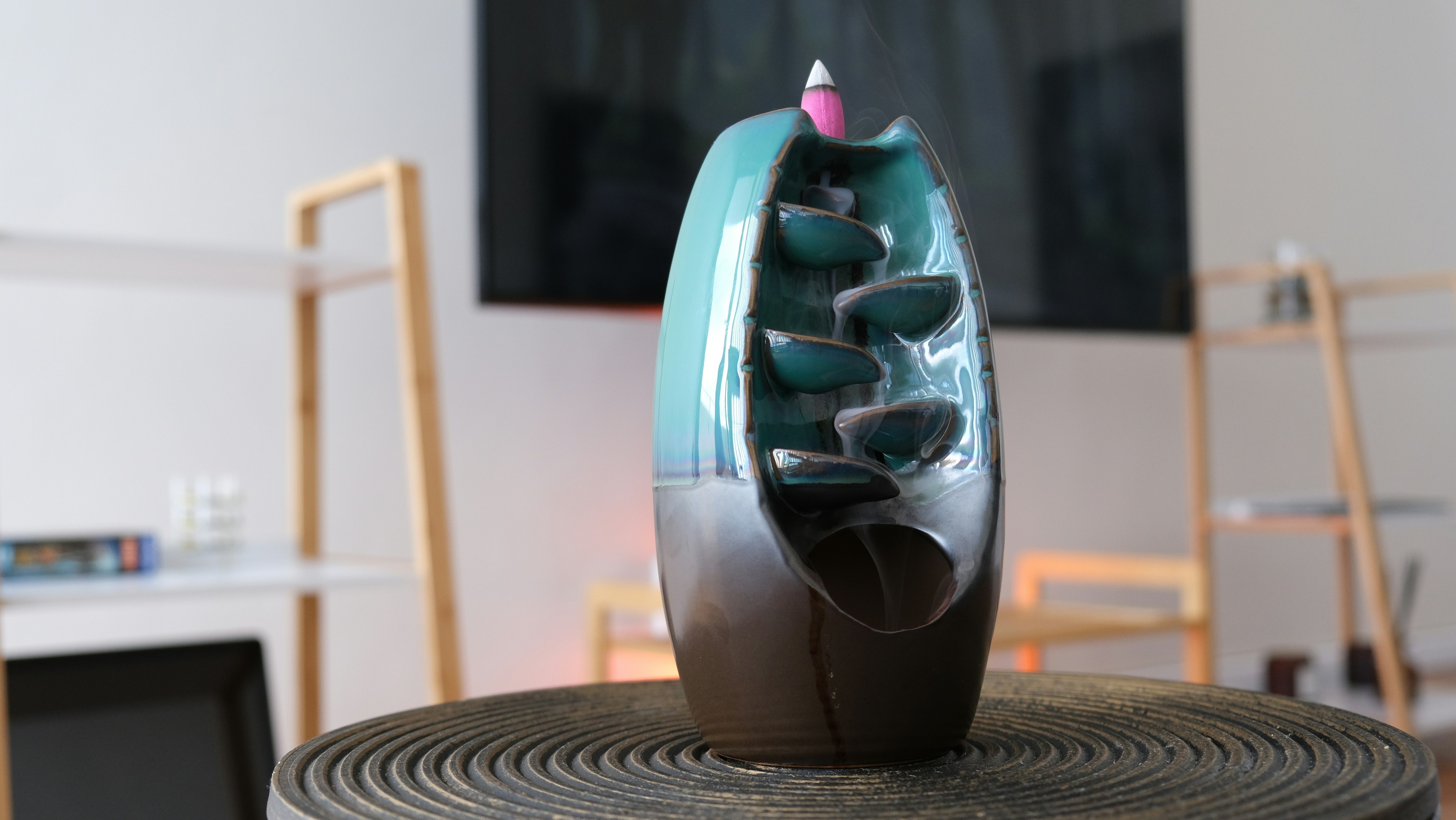 a vase sitting on top of a wooden table