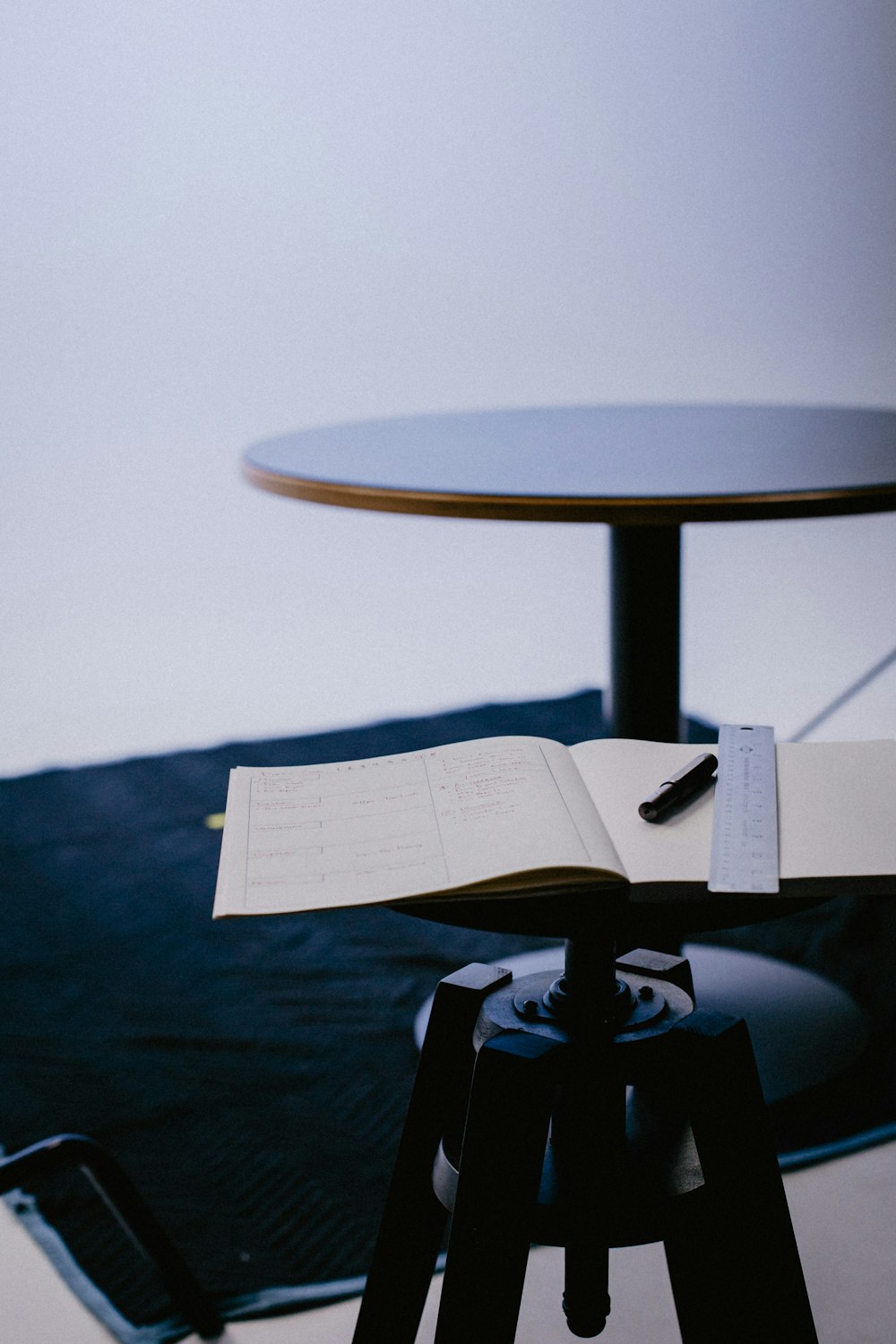 an open book sitting on top of a tripod