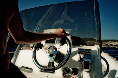 A woman steering a boat confidently through Lake Michigan's waves.