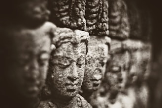 Ancient stone carvings of Mesopotamian deities under soft lighting.