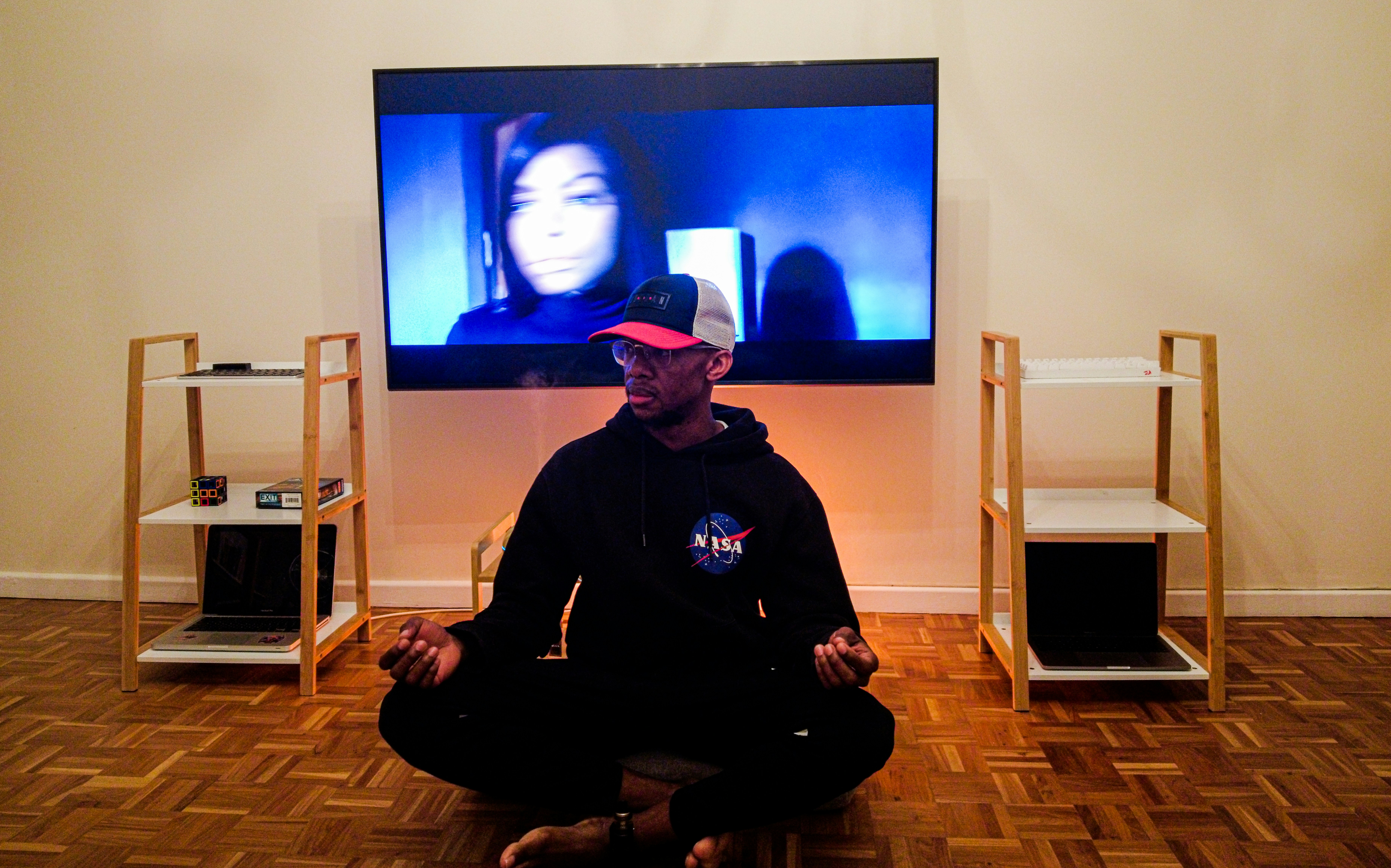 a man sitting on the floor in front of a tv