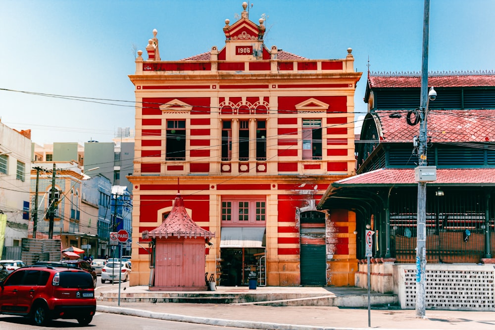 a red and yellow building on a city street