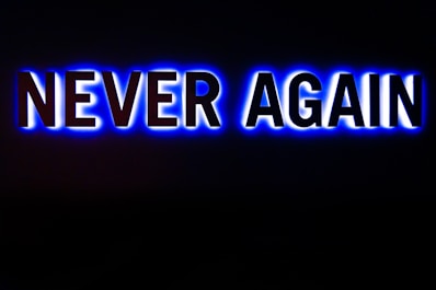 a neon sign that says never again