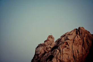 A rugged mountain peak at dawn symbolizing strength and endurance.