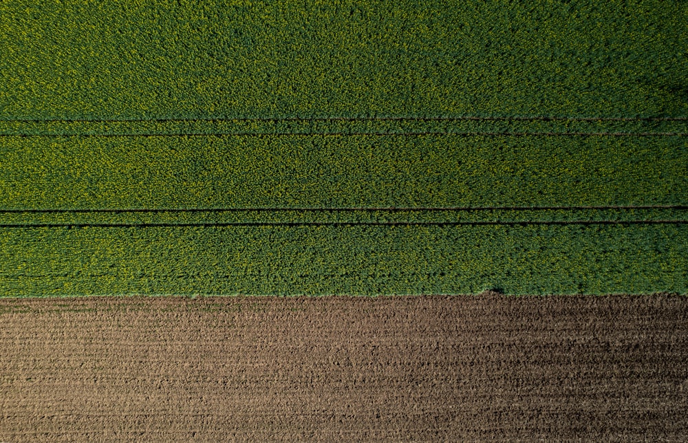 an aerial view of a field with a tractor in the middle of it