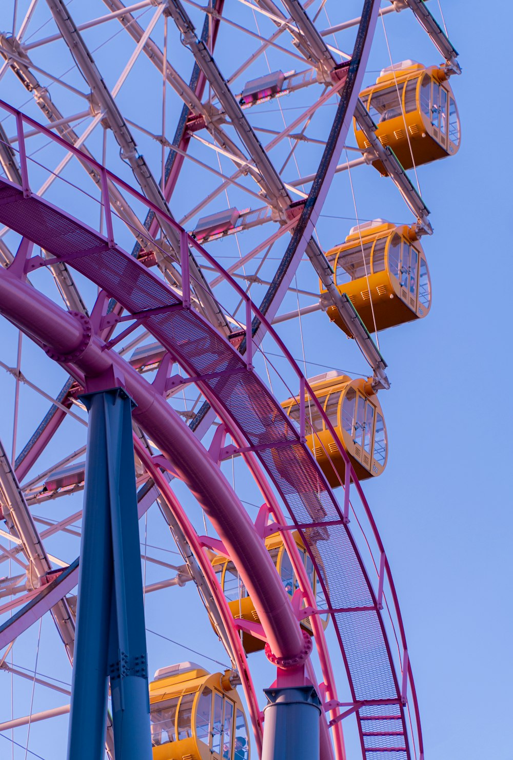 a colorful ferris wheel against a blue sky