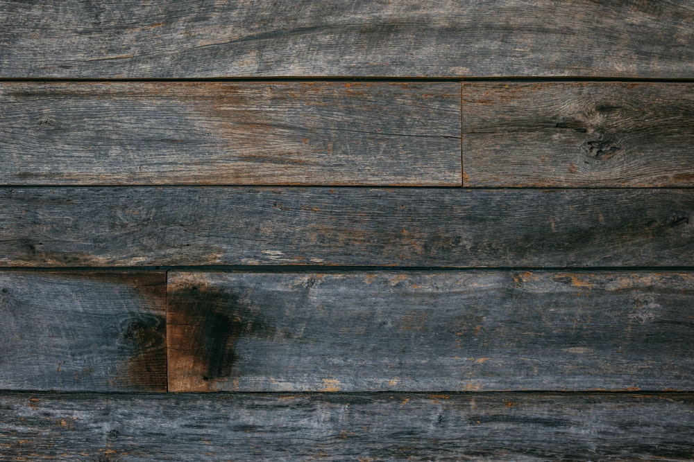 a close up of a wooden wall with a clock on it