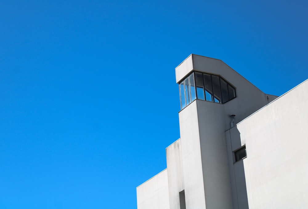 a tall white building with a sky background