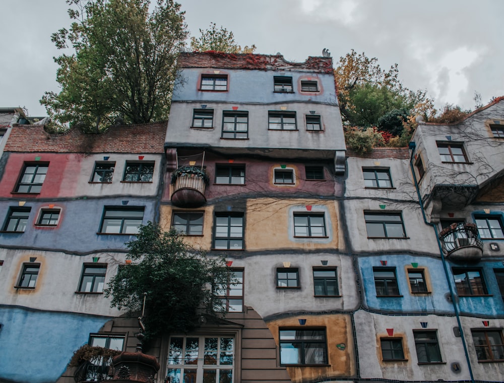 a multi - colored building with lots of windows and balconies