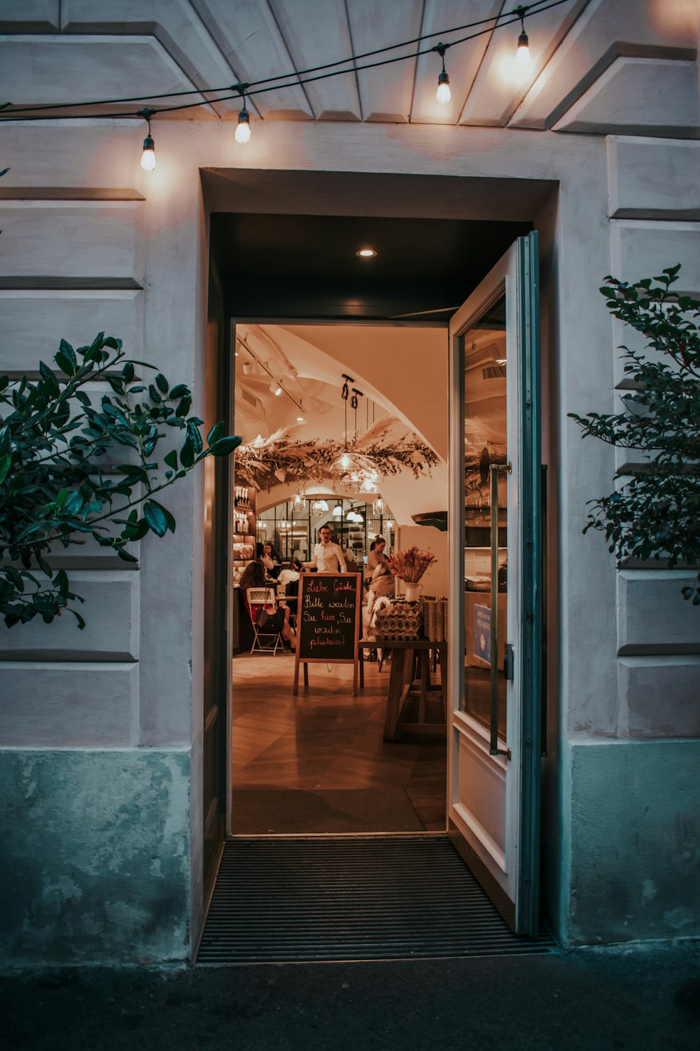 a doorway leading into a restaurant with a table and chairs