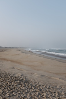 A serene beach scene with a traveler enjoying the sun.