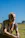 a man sitting on the ground in a field