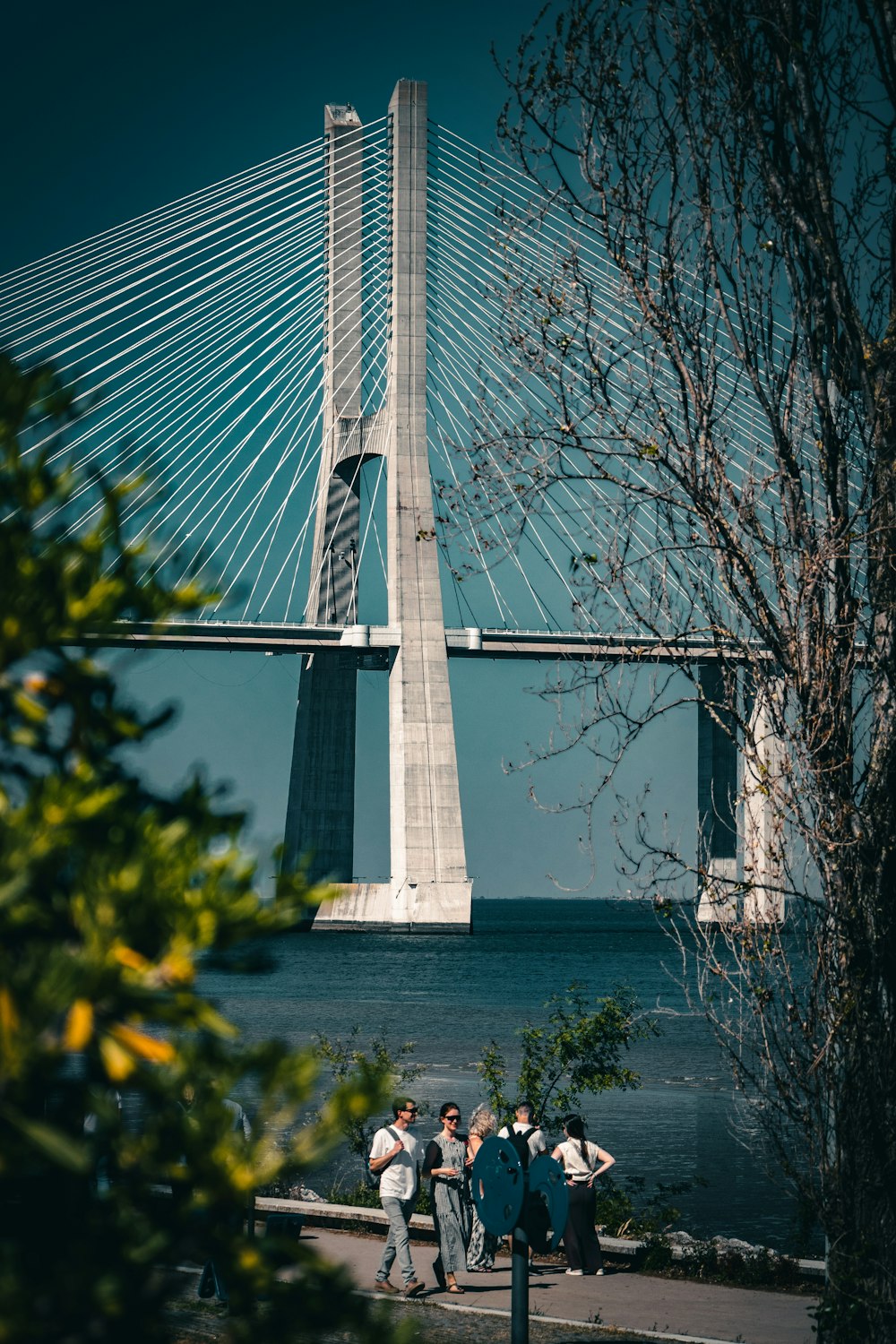 a group of people walking across a bridge