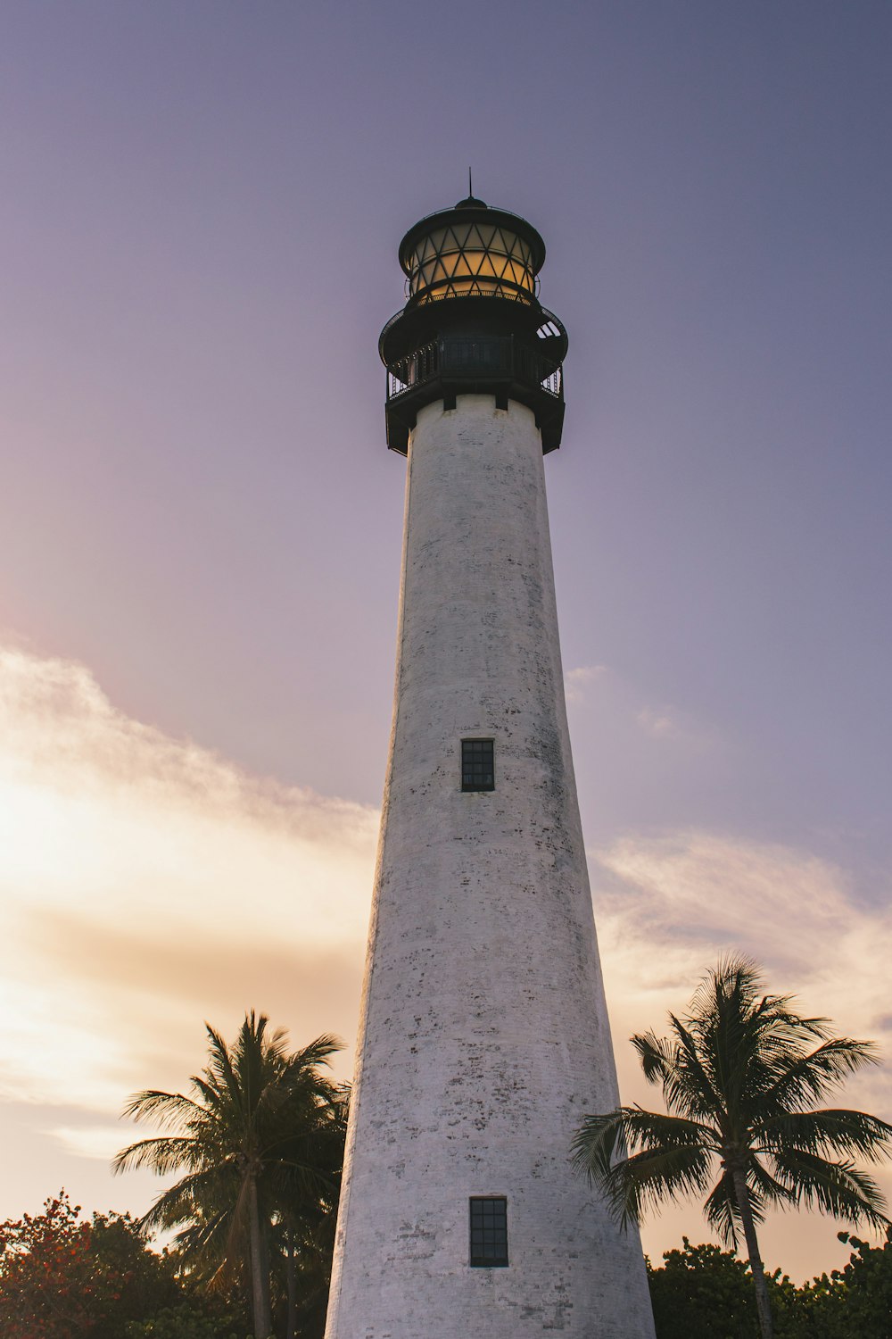a white lighthouse with a light on top of it