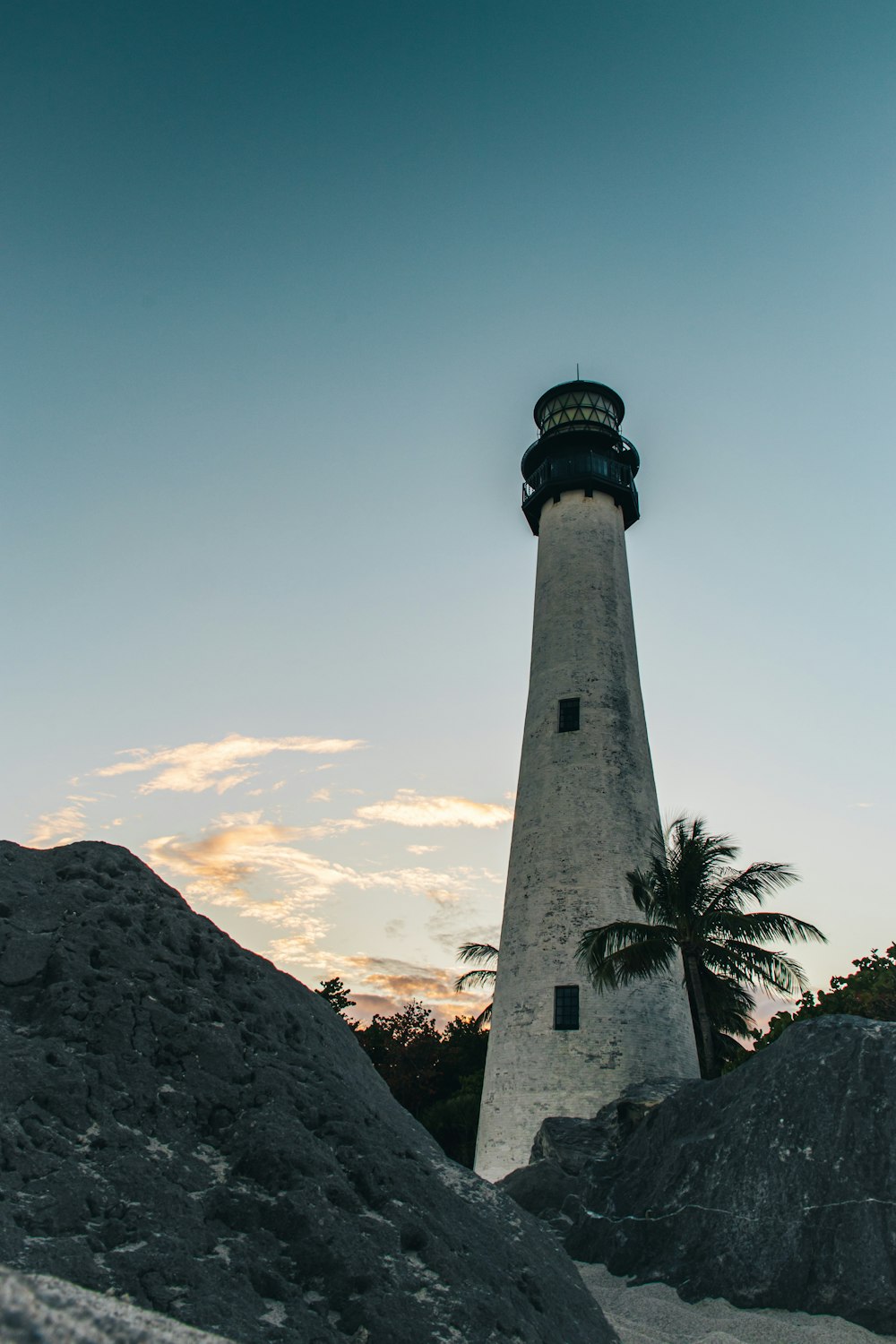 a light house sitting on top of a pile of rocks