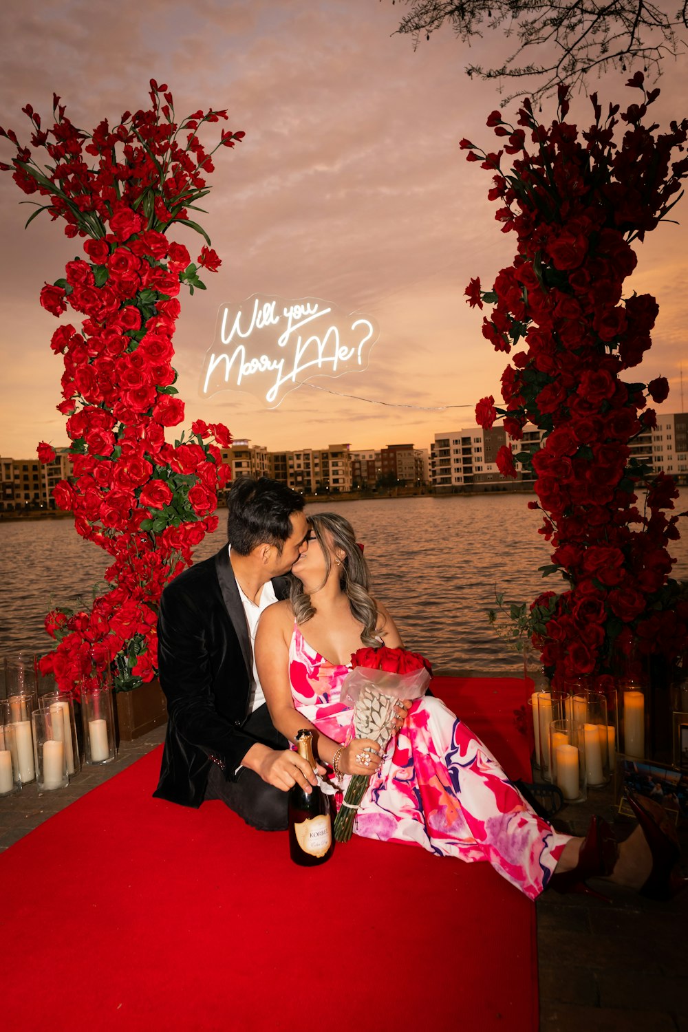 a man and a woman sitting on top of a red carpet