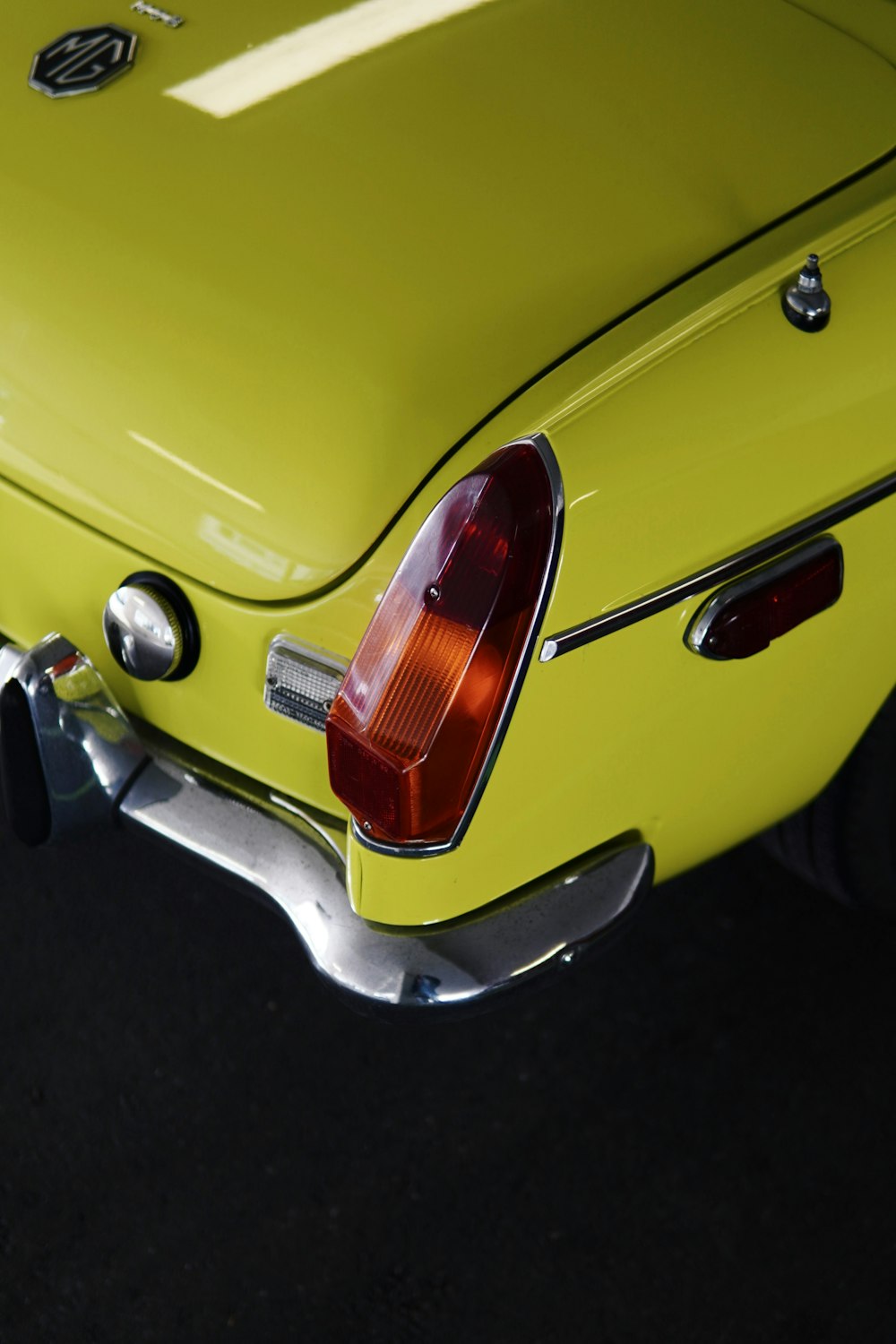 a close up of the tail end of a yellow sports car