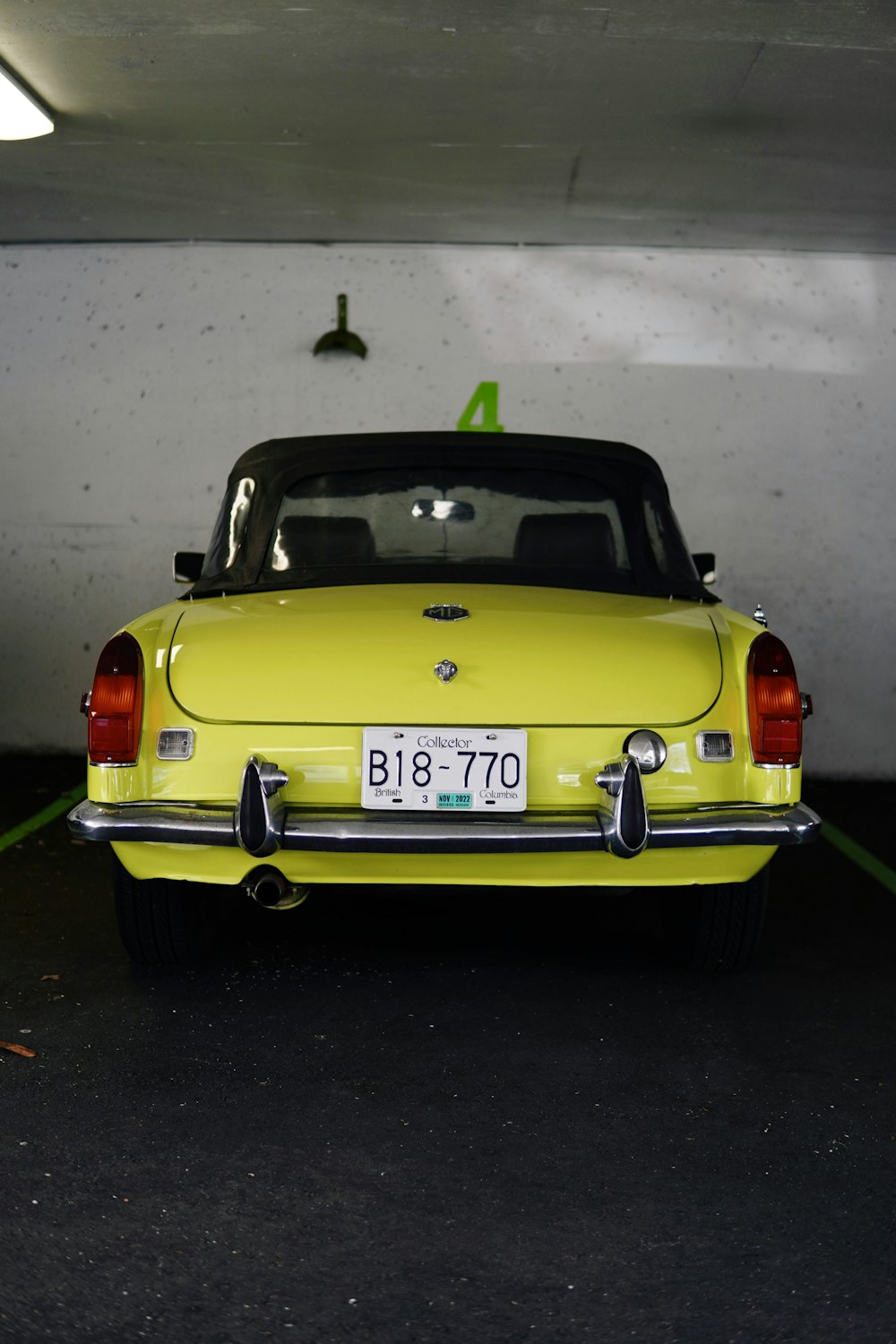 a yellow car parked in a parking garage