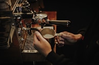 Picture of Ethan, casual and approachable, holding a pour-over coffee with steam rising.