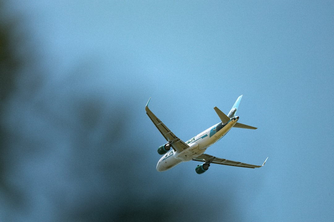 a large passenger jet flying through a blue sky,