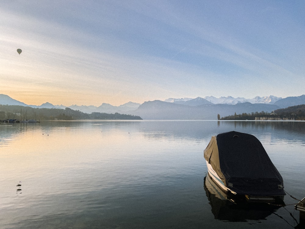 a boat sitting in the middle of a lake