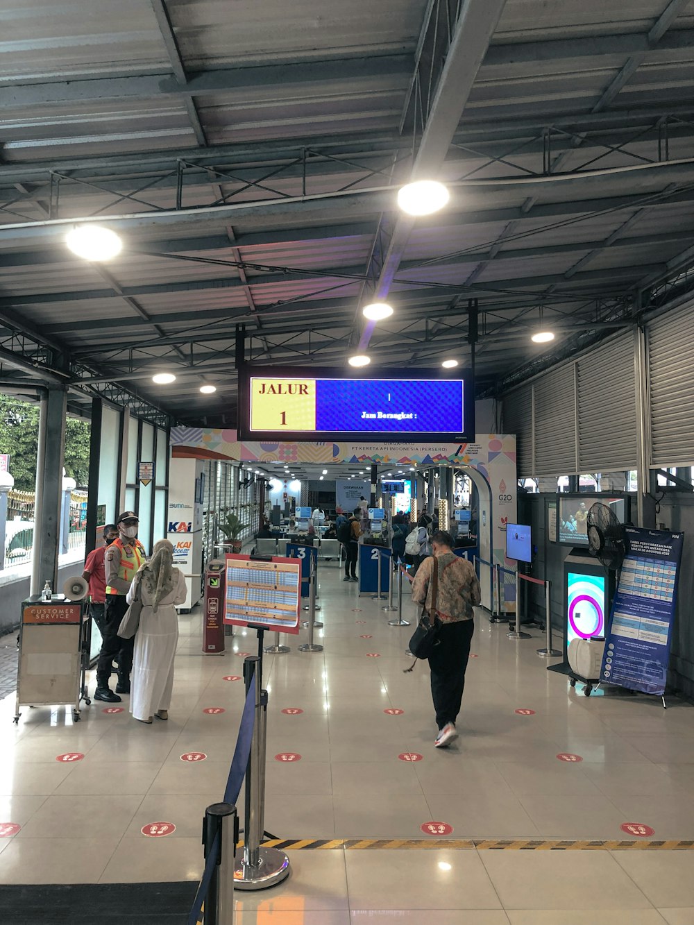 a group of people walking through a train station