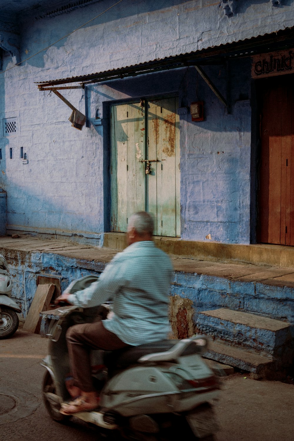 a man riding a motorcycle down a street