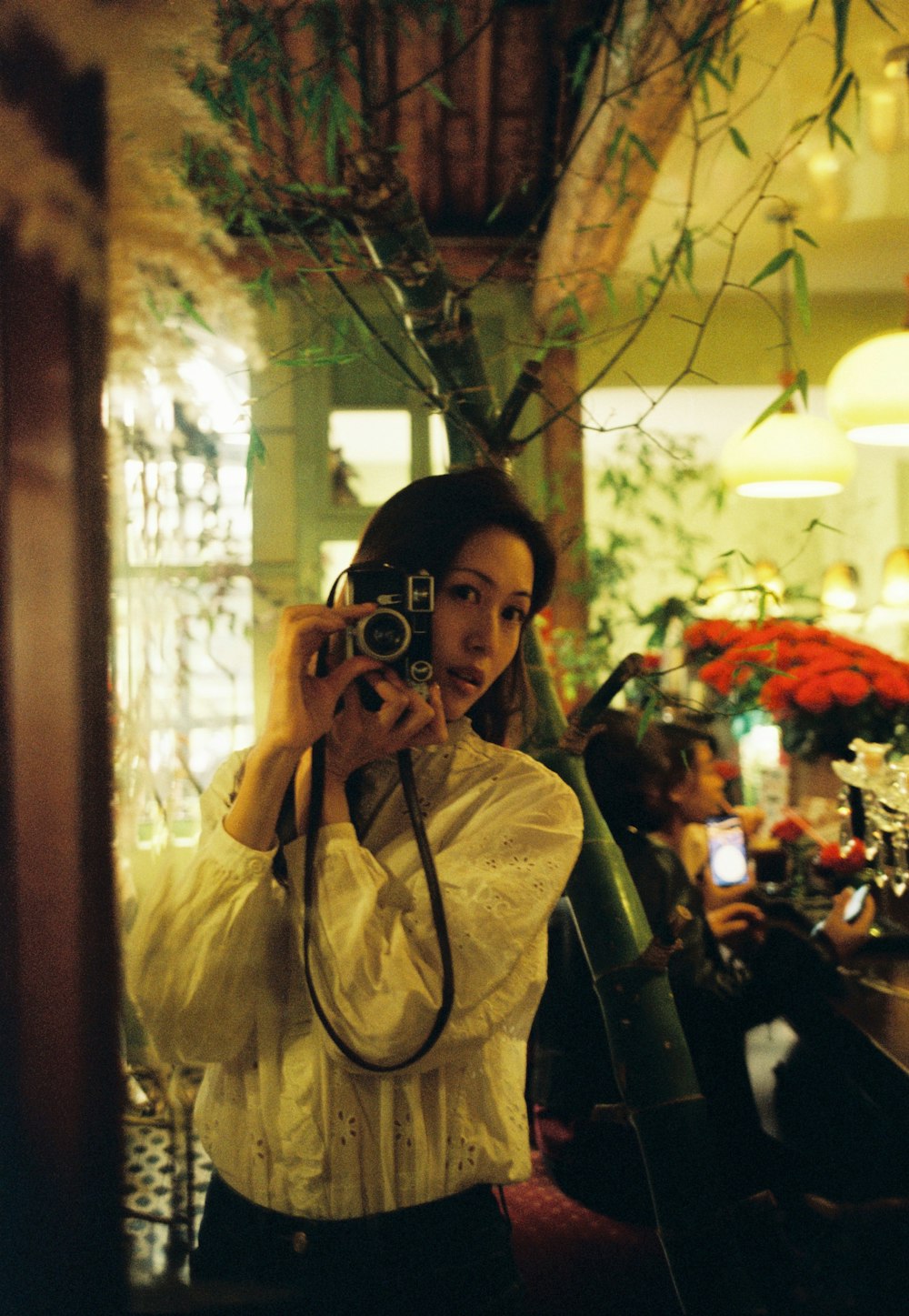 a woman taking a picture of herself with a camera