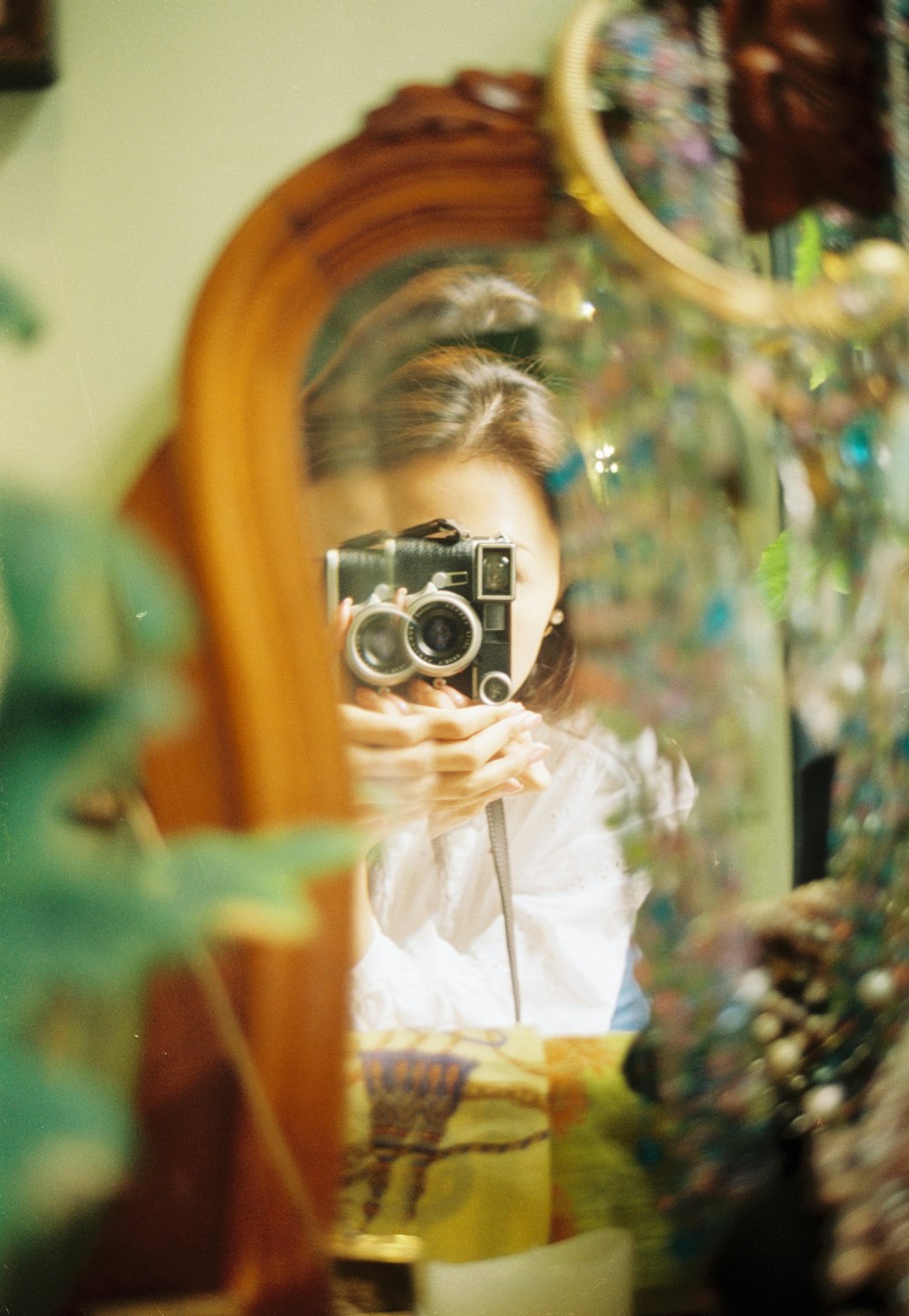 a woman taking a picture of herself in a mirror