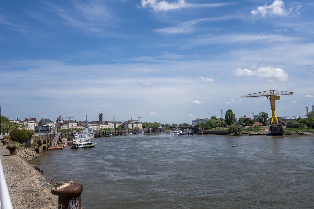 a body of water with a crane in the distance