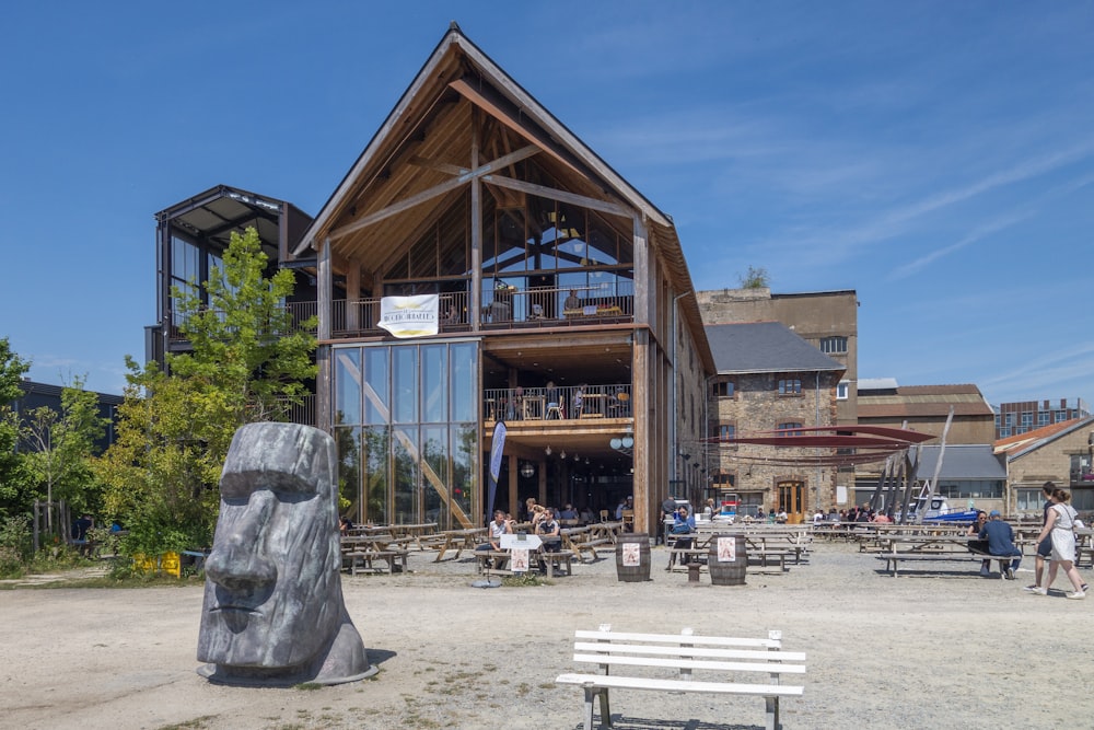 a wooden building with a large wooden sculpture in front of it