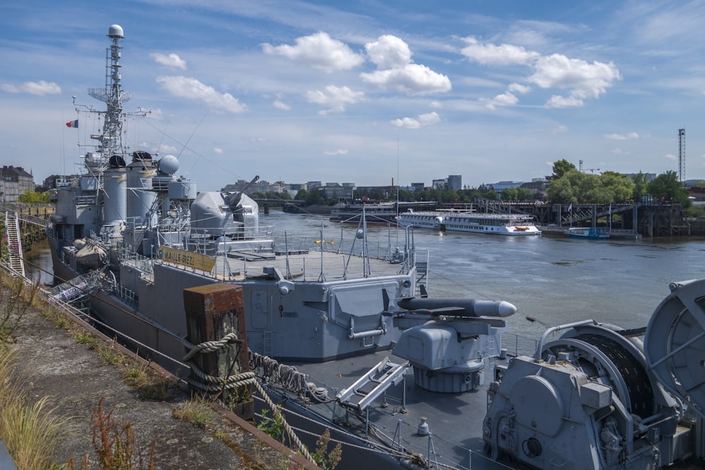 a large battleship sitting next to a body of water